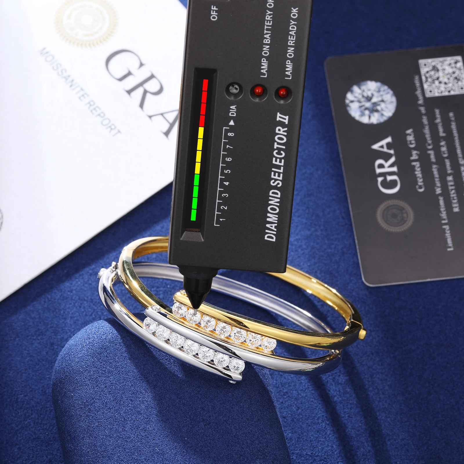 Diamond selector tool with three diamond-studded bracelets on a blue surface, with &