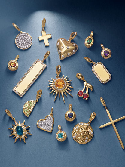Collection of gold pendants with various designs on a blue background