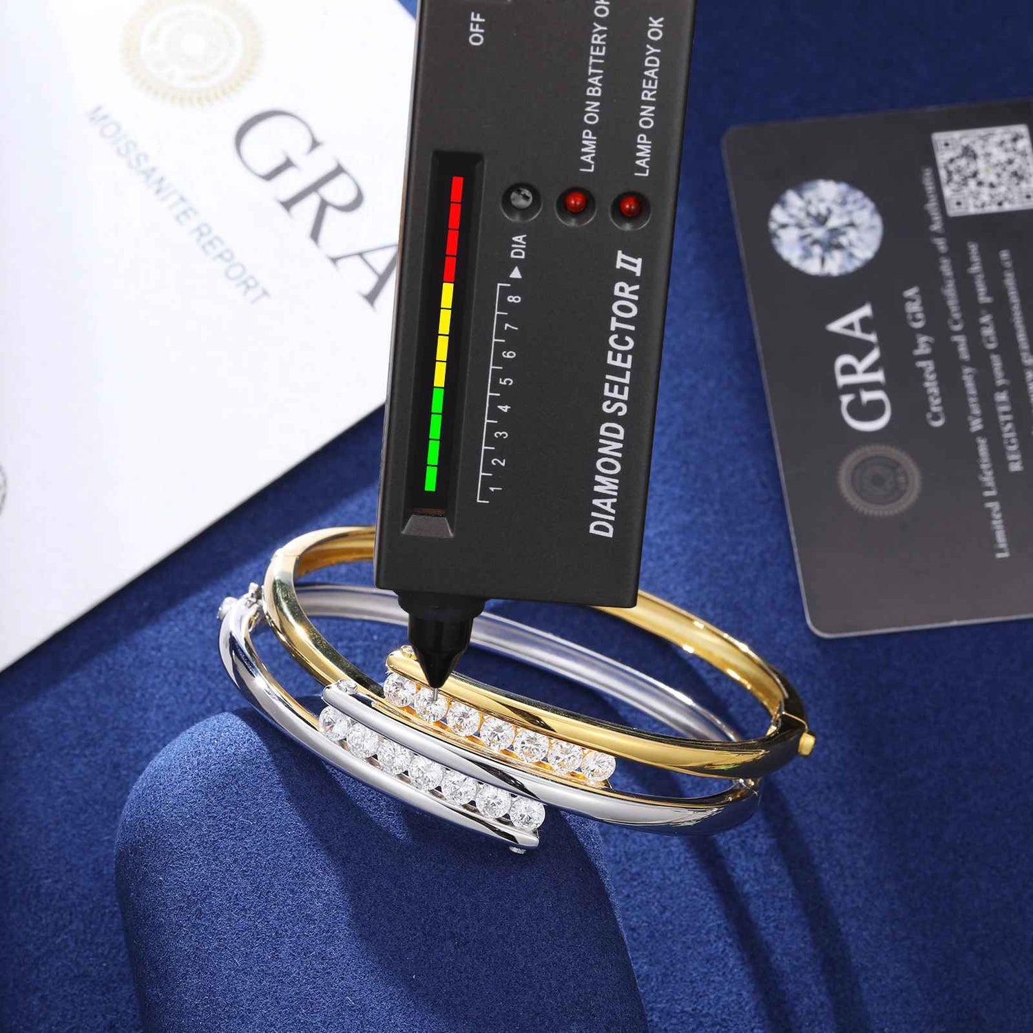 Diamond selector tool with three diamond-studded bracelets on a blue surface, with &