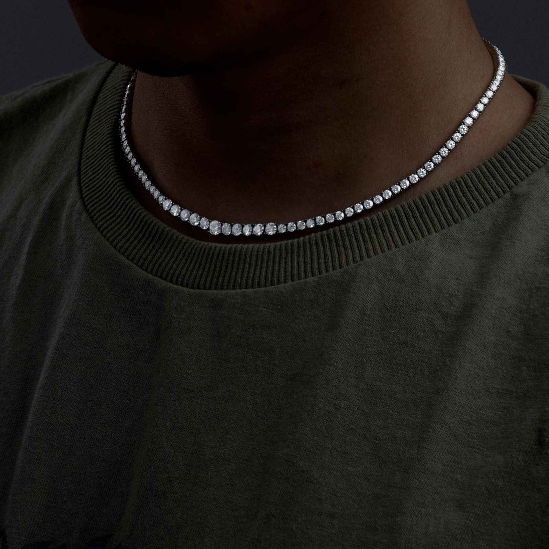 Person wearing a silver necklace with a dark background - Moissanite Necklace - affordable
