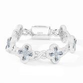 Silver bracelet with floral designs on a white background
