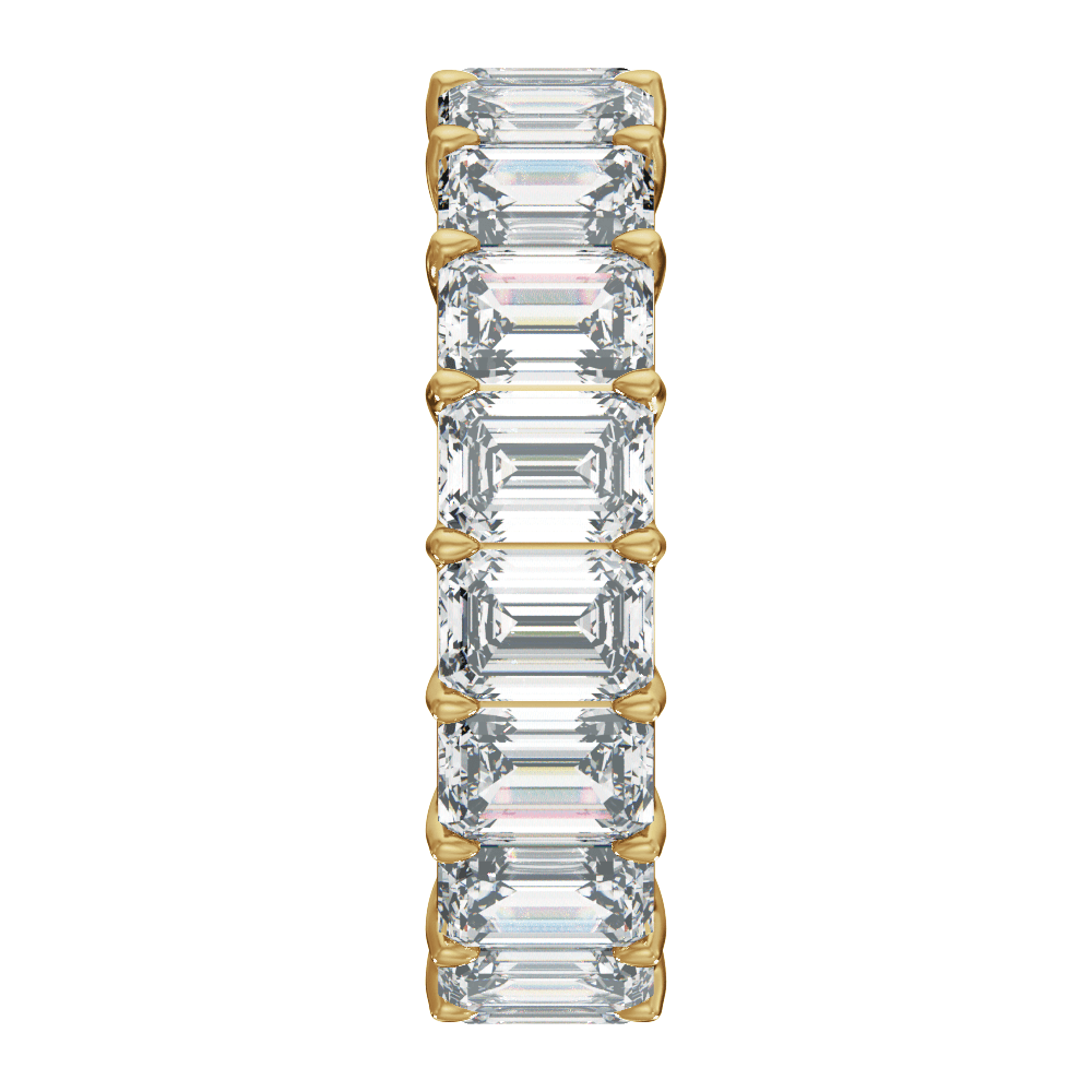 A vertical eternity-style ring featuring a row of baguette-cut clear gemstones set in yellow gold prongs, centered on a plain white background.