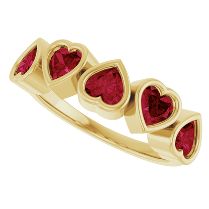Front view of five 4 × 4 mm AA natural Mozambique garnets bezel set across a polished yellow gold ring