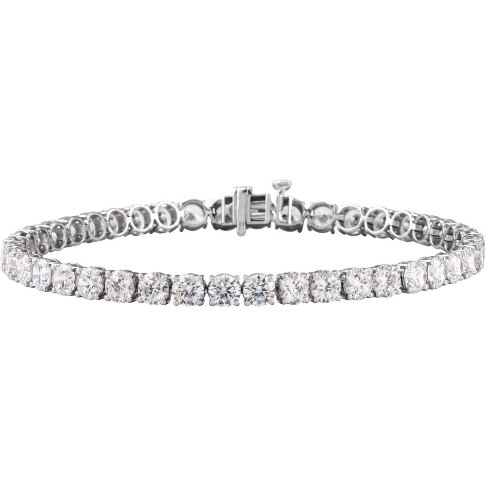 Angled view of a 14K white gold lab-grown diamond tennis bracelet with four-prong settings and a box clasp