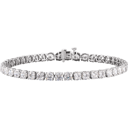 Angled view of a 14K white gold lab-grown diamond tennis bracelet with four-prong settings and a box clasp