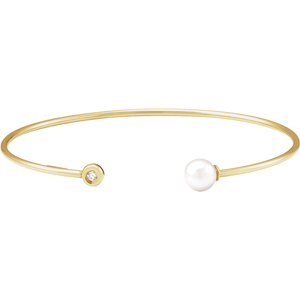 Close-up of AA freshwater pearl and 0.03 CT round natural diamond on 14K gold cuff bracelet