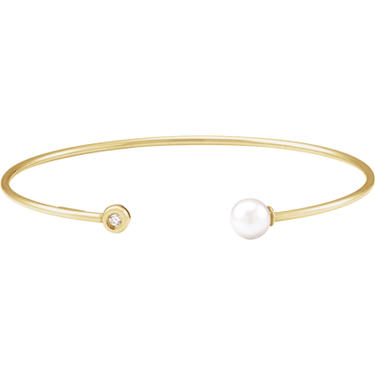 Close-up of AA freshwater pearl and 0.03 CT round natural diamond on 14K gold cuff bracelet