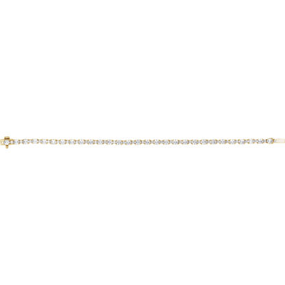 A delicate yellow gold tennis bracelet with a row of small clear round-cut gemstones, shown horizontally against a plain white background.