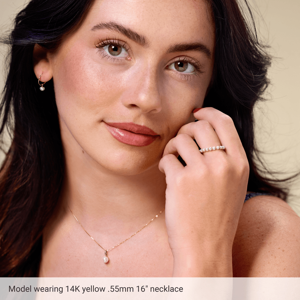 Full view of an 18-inch solid 14K yellow gold box chain necklace measuring 0.55 mm wide