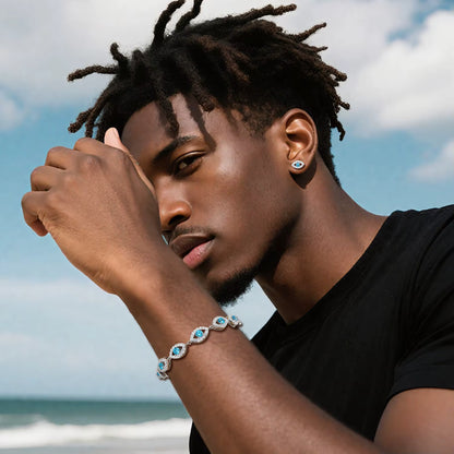 Man wearing a bracelet with blue stones against a beach background