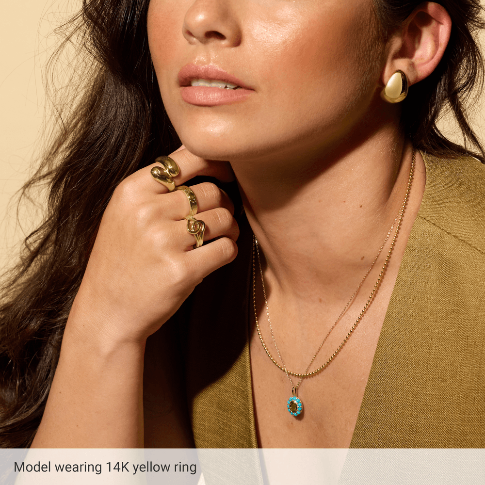 Model wearing Guerilla Choice sculptural 14K yellow gold statement ring